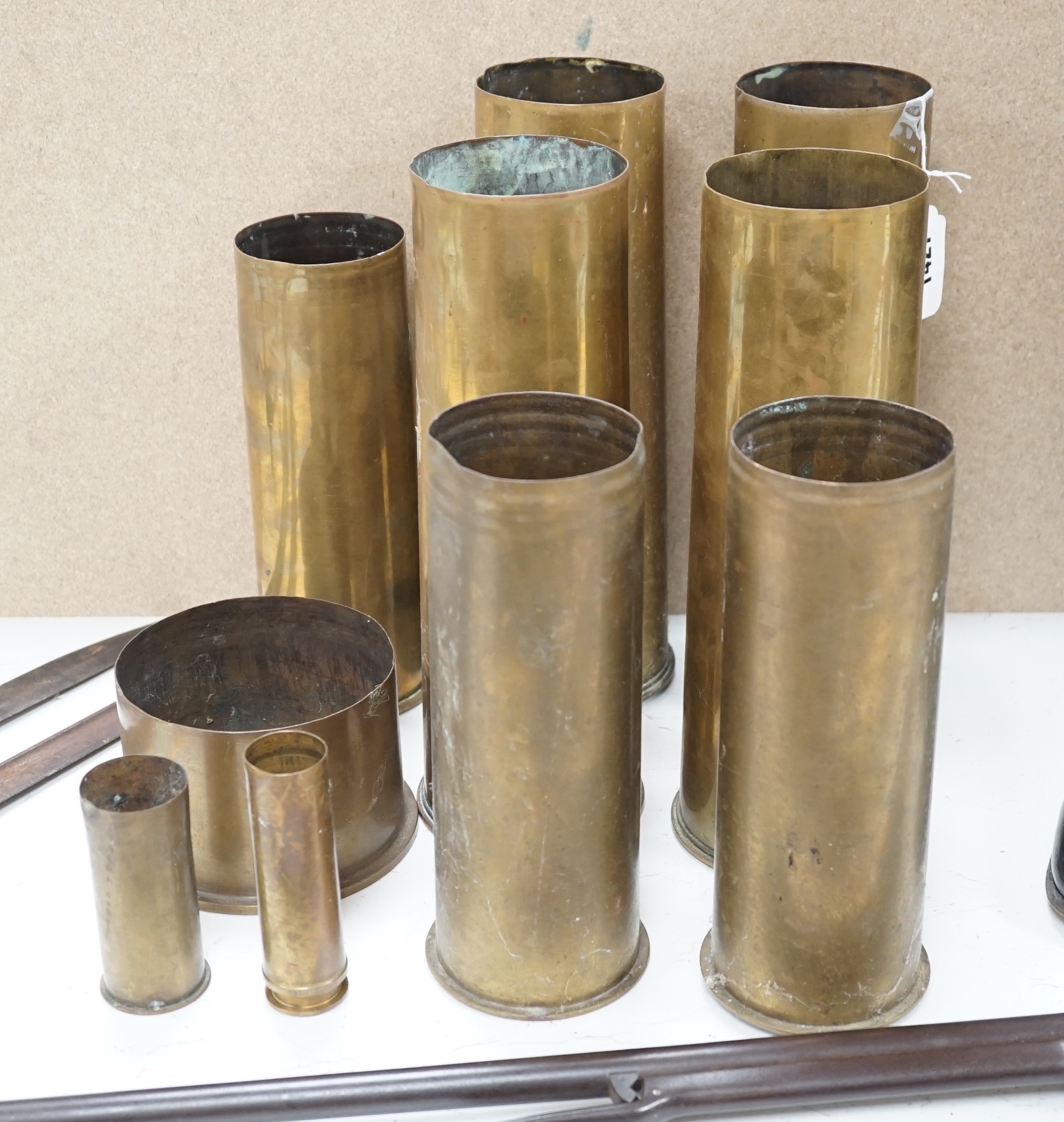 A group of WWI shell casings and two bayonets